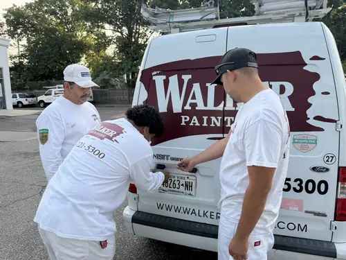Walker Painting crew gathered around the open work van